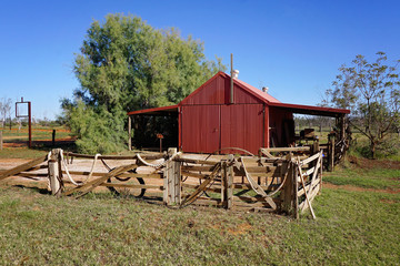 A rope decorated fence in front of rustic barn, Thargarmindah Western Queensland.