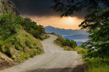 road in the mountains with dramatic sky