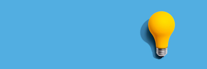 Yellow light bulb - flat lay from above