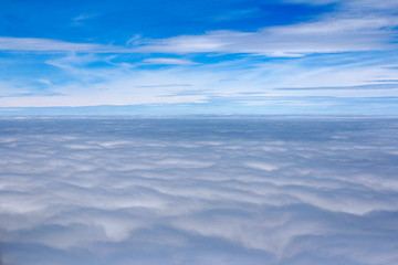 Fototapeta na wymiar Dramatic cloudscape from the airplane's window