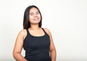 Portrait of happy young overweight Asian woman