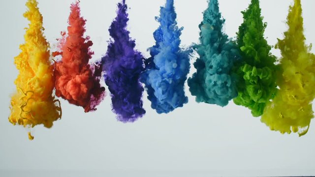 Palette of bright colored liquids exploding and mixing in slow motion.