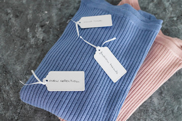 shopping concept, knit jumpers in alternative colours with New Collection Fashion Trends and Must Have texts on price tags
