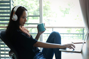 Young woman listening to music enjoying the music at home.