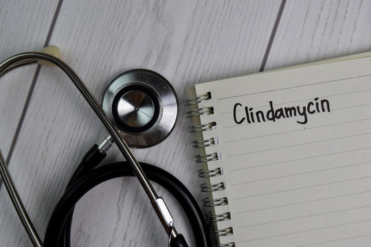 Clindamycin text write on a book isolated on office desk. Healthcare/Medical concept