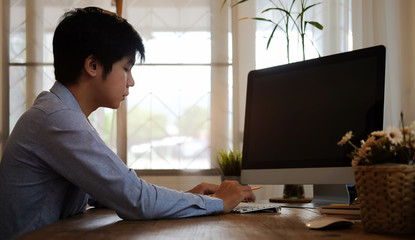 Concept business man working and people happy businessman or creative female office worker with computers writing to notebook with documents and laptop.