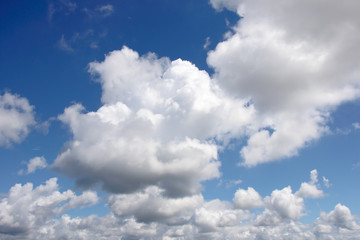 Fototapeta na wymiar White fluffy clouds on a gentle blue sky