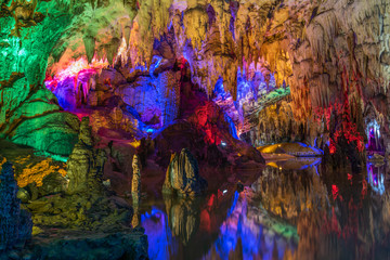Fototapeta na wymiar Underground cave stalactites and groundwater landscape