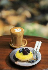 Sweet lemon cake with Piccolo hot coffee on wooden table 