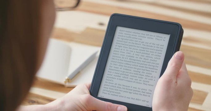 Woman reading an ebook on a reader with an e-ink display.