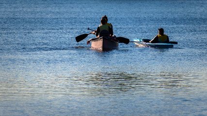 kayaking on the river, three people paddling 