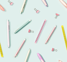 Creative seamless pattern with office supplies, color pencils, pens, puler, markers and metal paper clips. School and education concept.