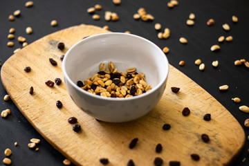 Bowl of peanuts with raisins 