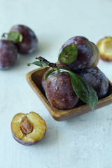 fresh plums on a wooden table
