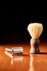 old shaving machine with a shaving brush isolated on black