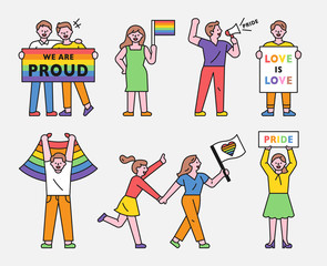 LGBT people are holding rainbow flags and pickets. flat design style minimal vector illustration.