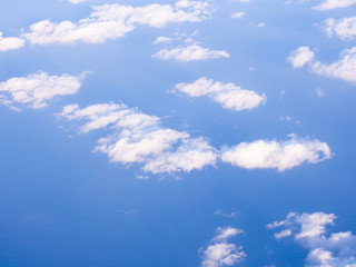 Naklejka na ściany i meble Blue sky background with white fluffy clouds.