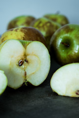 sliced green and brown apple on a table 