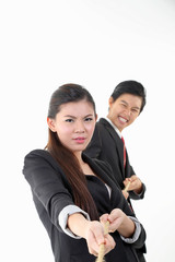 South East Asian young Chinese man woman wearing formal business office ware on white background pulling rope tug of war