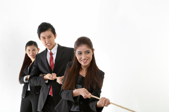 South East Asian young Chinese Indian man woman wearing formal business office ware on white background pulling rope tug of war - Powered by Adobe