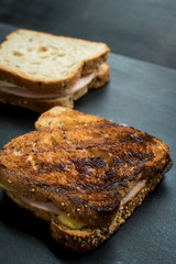 Fresh sandwich with jam and cheese on a dark wooden table 
