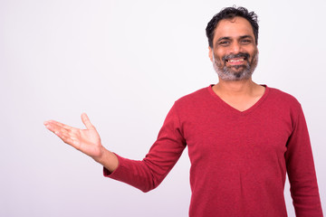 Portrait of happy mature handsome bearded Indian man