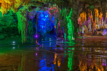 Fototapeta na wymiar Ancient underground cave stalactites and groundwater landscape