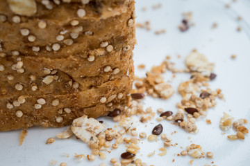 Bread with grains and some corn on a white plate 