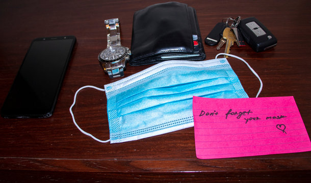 New Reality. Picture Of A Phone, Keys, Wallet, Watch Surgical Mask And Note