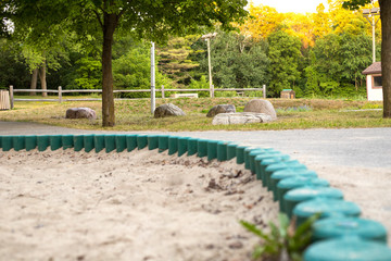 sandbox close-up in the local park in the evening during sunset with blurred foreground and without people