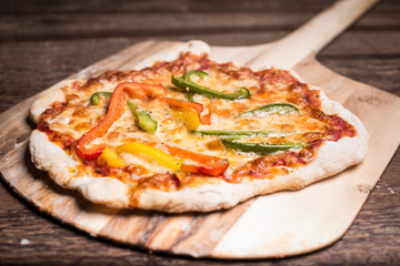 pizza on a wooden baking tray