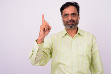 Naklejka premium Portrait of mature handsome bearded Indian businessman