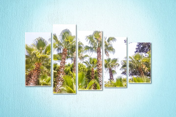 Fototapeta premium Five canvas set isolated on light blue painted wall with palms view posters. Interior decor mock up