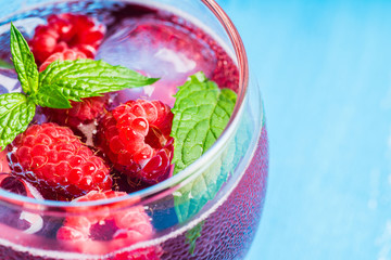 Raspberry and mint cocktail in glass on the rustic background. Selective focus. Shallow depth of field.
