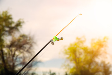 Fototapeta premium Biting alarm-a bell, on the tip of the feeder rod. Bottom tackle