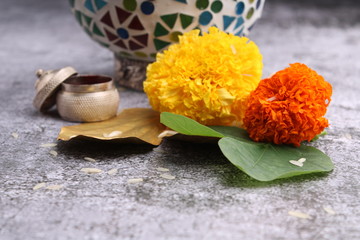 Dussehra or Vijay dashmi greeting , green leaf, marigold flowers and kumkum.