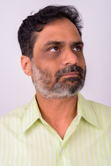 Fototapeta premium Portrait of mature handsome bearded Indian businessman
