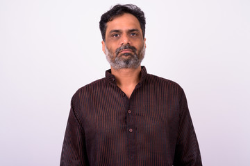 Portrait of mature handsome bearded Indian businessman