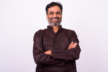 Portrait of happy mature handsome bearded Indian businessman