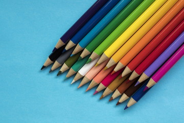 Colored pencils on blue background