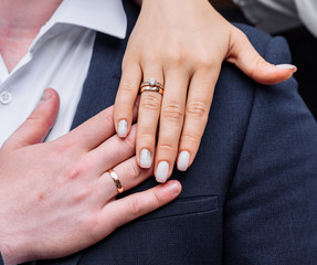 young people with twisted hands on which wedding engagement rings in white gold with diamonds. wedding ceremony marriage
