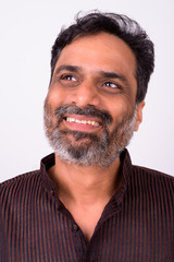 Obraz premium Portrait of happy mature handsome bearded Indian businessman