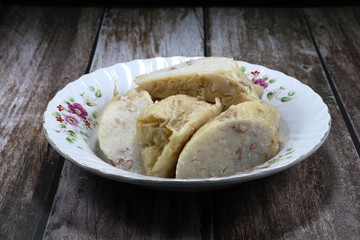 Pile of cutting Daikon rolls, famous Chinese dim sum menu in Asia. Traditional sliced fresh Daikon or white Radish and boiled peanut wrapped with dried tofu sheet on the plate. 