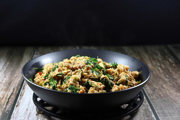 Traditional fried and stirred minced pork, chilly and basil, seasoning with fish sauce and sugar. Famous Thai spicy street food menu in Thailand. Quick and easy meal in rush hour. Comfort food. 