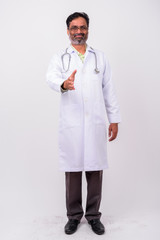 Portrait of mature handsome bearded Indian man doctor