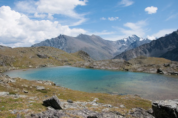 Naklejka na ściany i meble Picturesque glacial lake with turquoise water and Altai mountains in the background, the Altai Republic, Russian Federation
