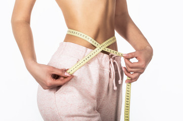 Woman with measuring tape. Weight loss concept. Woman take waist scale tape show her thin waist....