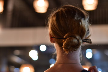 closeup of a nape of young blond caucasian girl with bokeh blurred background
