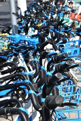 Tianjin, China - Circa 2019: A lot of Chinese bike sharing service bikes are parked along the street