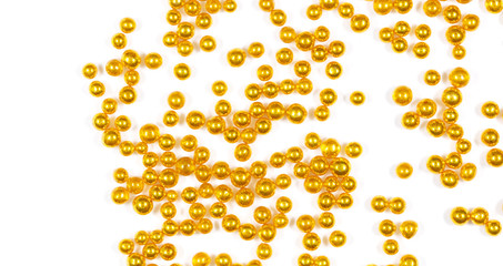 Small balls of gold on a white background.